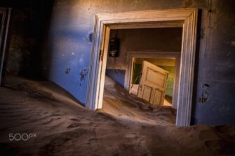 Desert sand filling the rooms of an abandoned house in Kolmanskop, Namibia