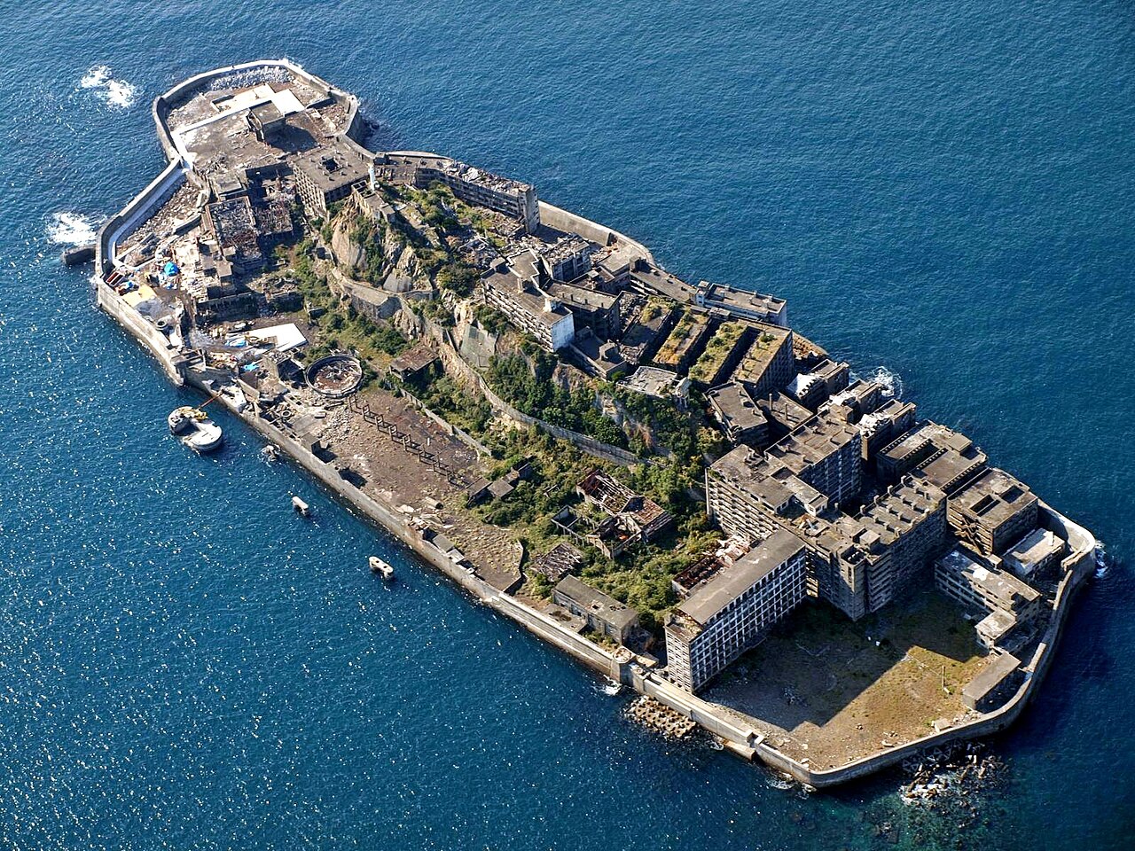 Crumbling concrete apartment blocks and seawalls on Hashima Island near Nagasaki