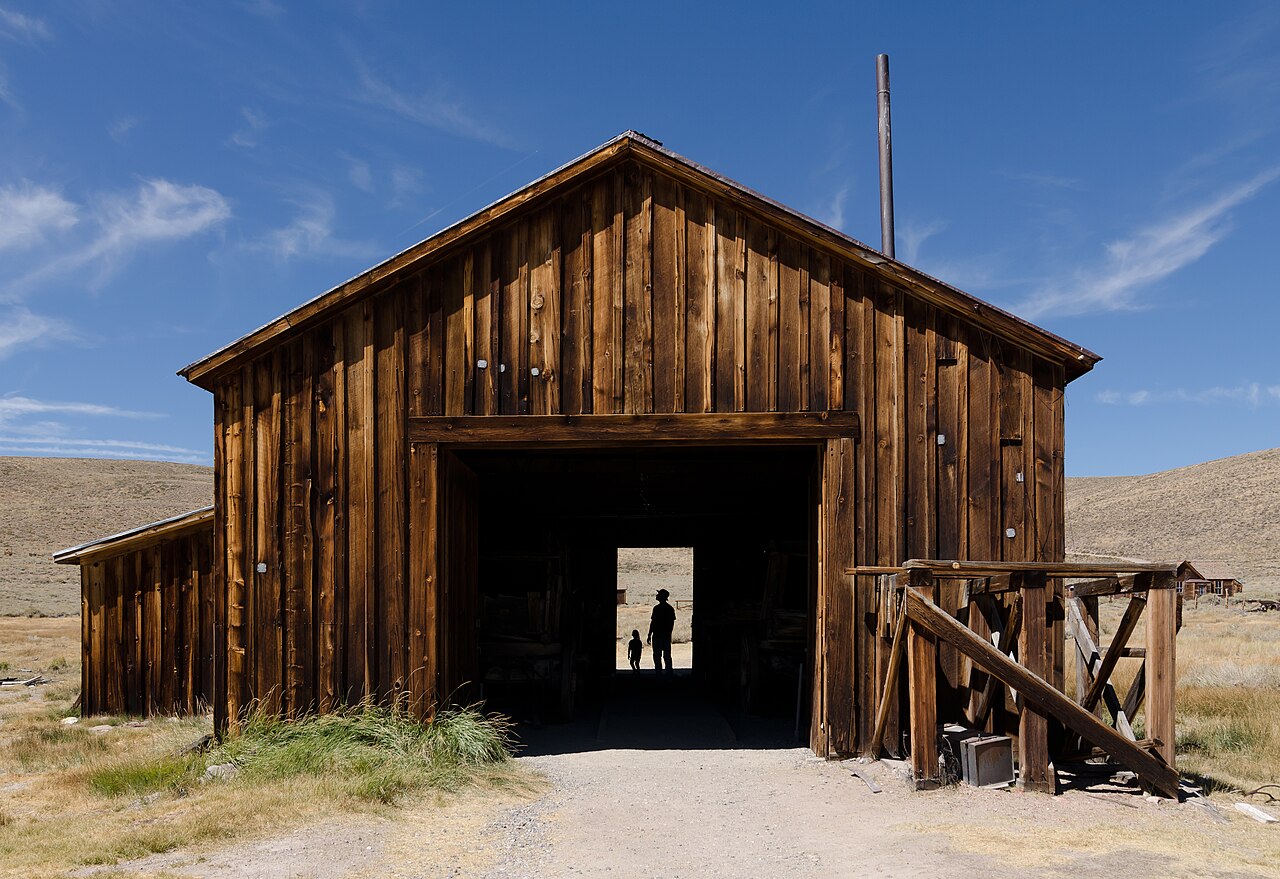 Weathered wooden buildings of the Bodie ghost town on a dry, open hillside