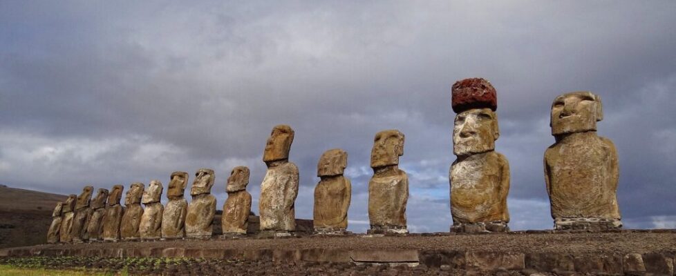A long row of giant moai statues on a stone platform at Ahu Tongariki, Easter Island