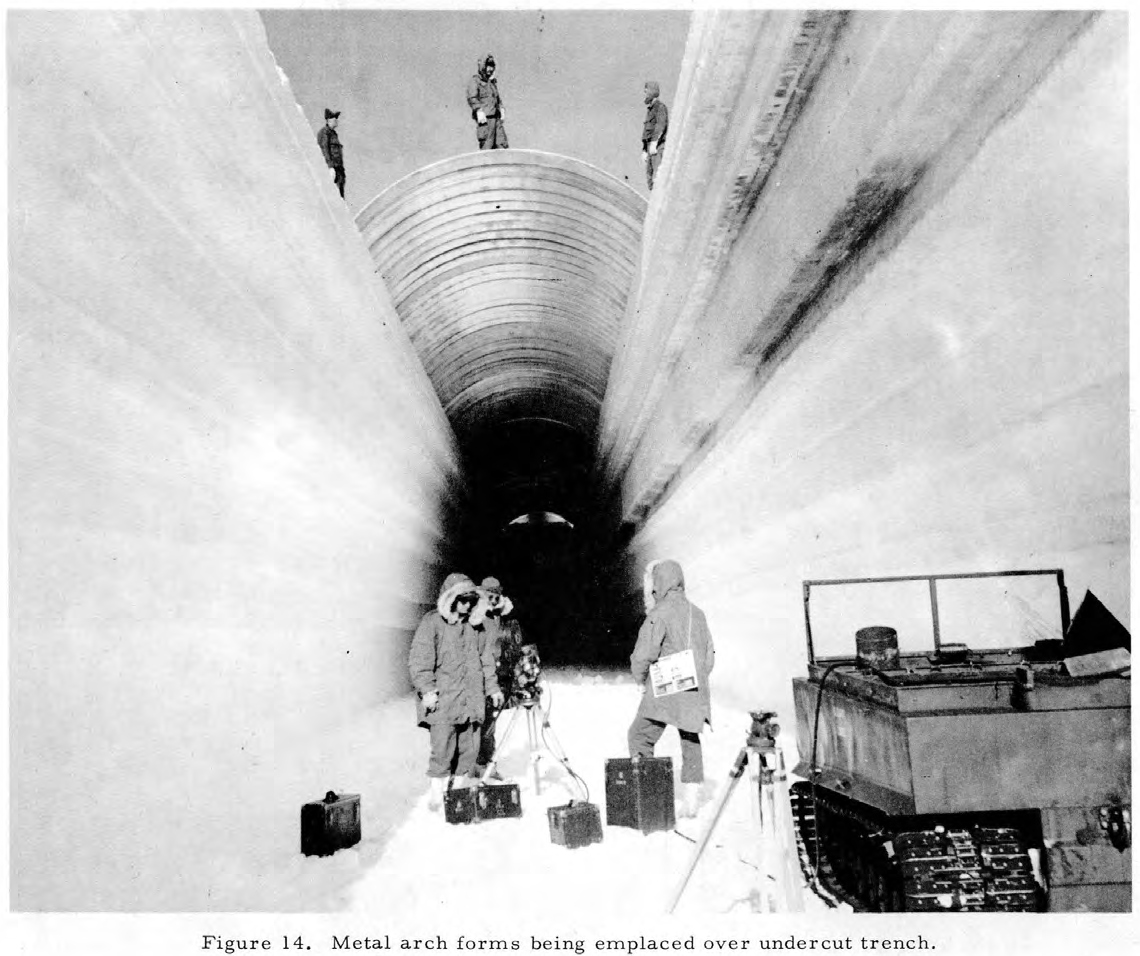 A vehicle inside one of the snow-covered trenches carved for Camp Century in Greenland