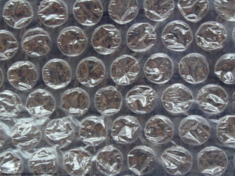 Close-up of bubble wrap, rows of small air-filled plastic bubbles