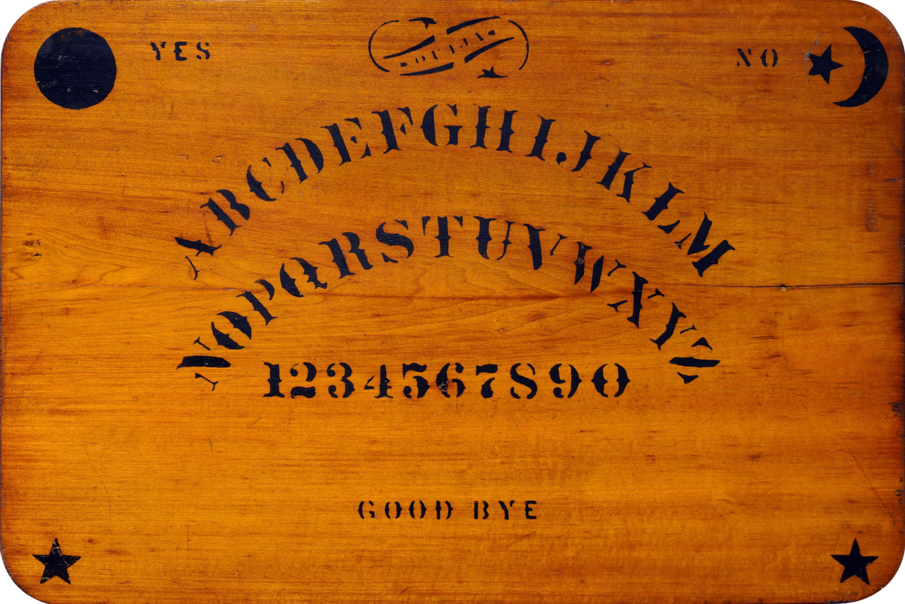 A vintage Ouija talking board printed with the alphabet, numbers, yes and no