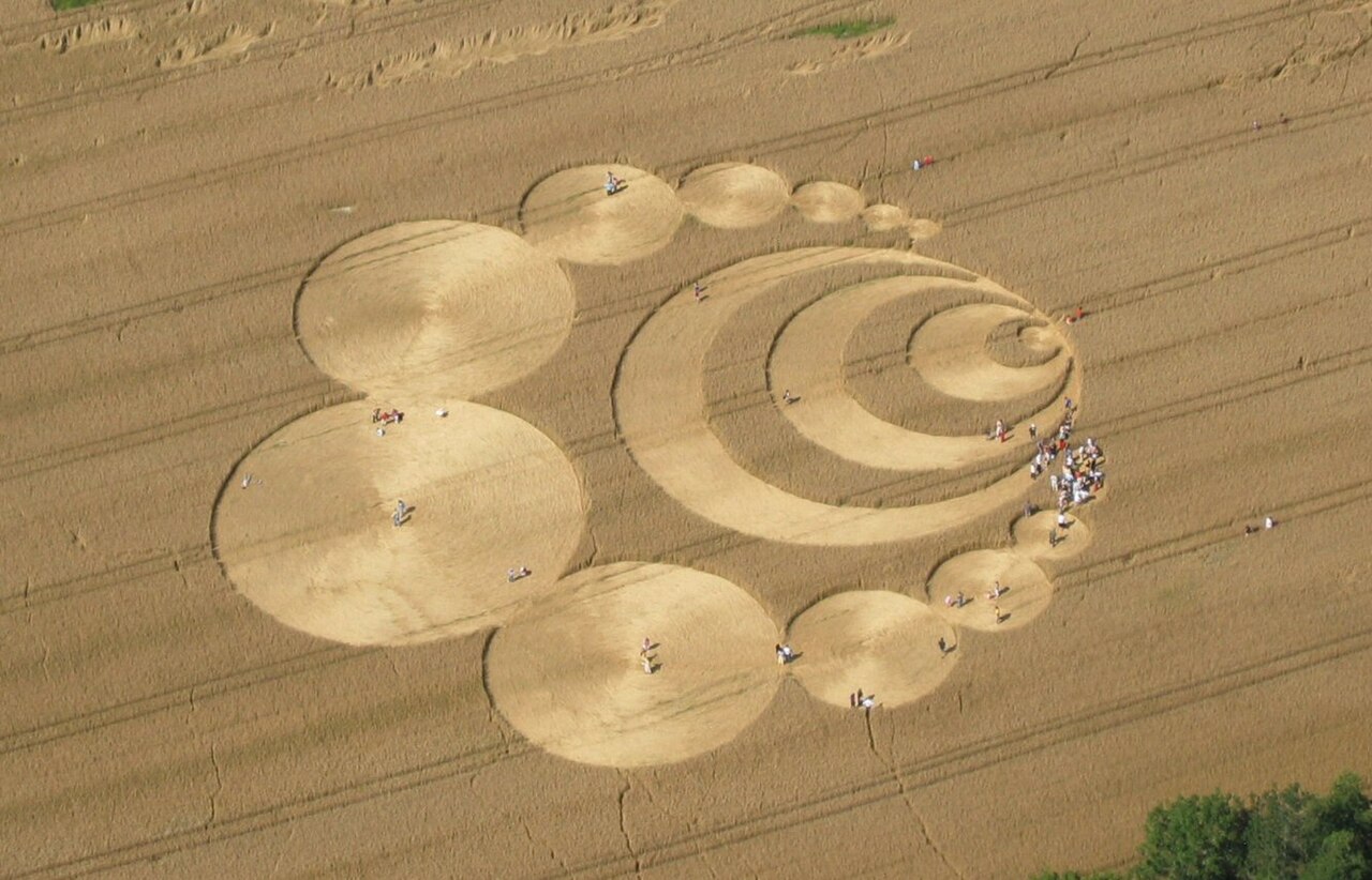 An intricate geometric crop circle flattened into a field of grain, seen from above