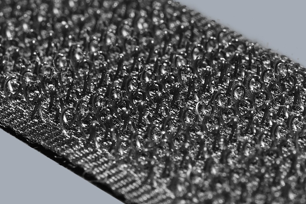 Close-up of hook-and-loop fastener strips showing tiny hooks and soft loops