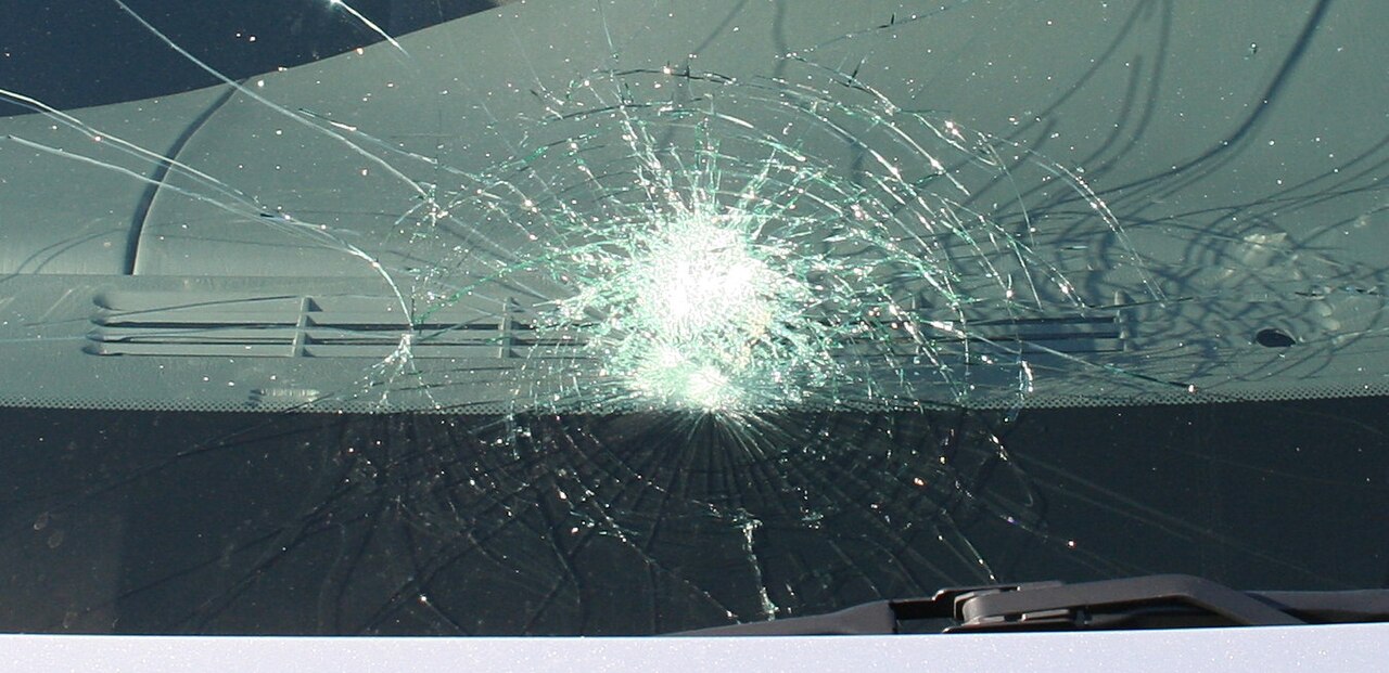 Cracked laminated safety glass holding together in one piece instead of shattering