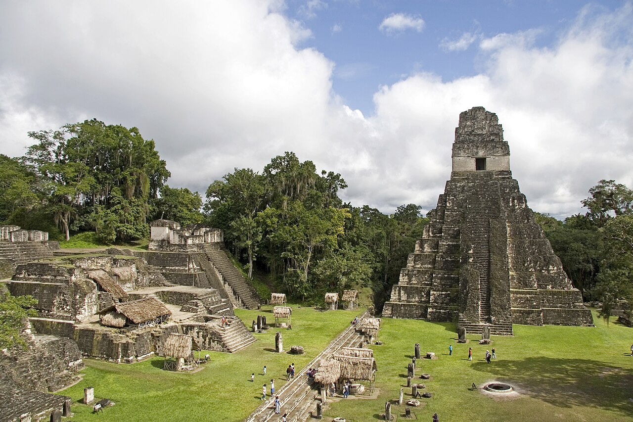 A steep stone Maya pyramid temple rising above the Great Plaza at Tikal, Guatemala