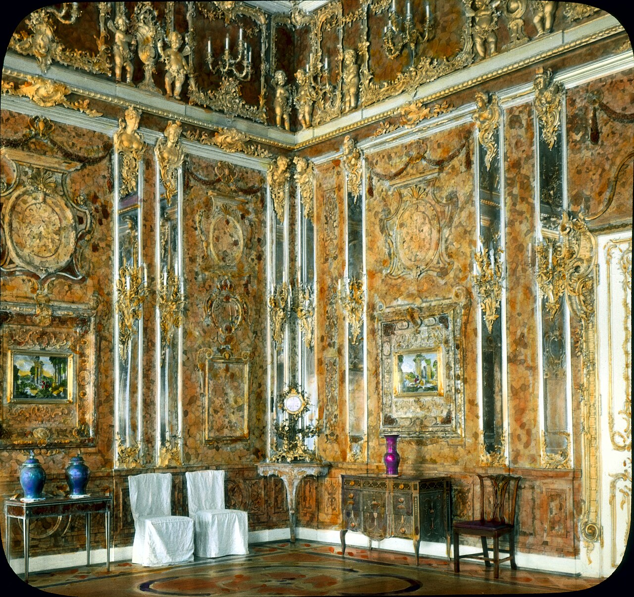 Ornate walls covered in carved amber panels inside the Amber Room of the Catherine Palace