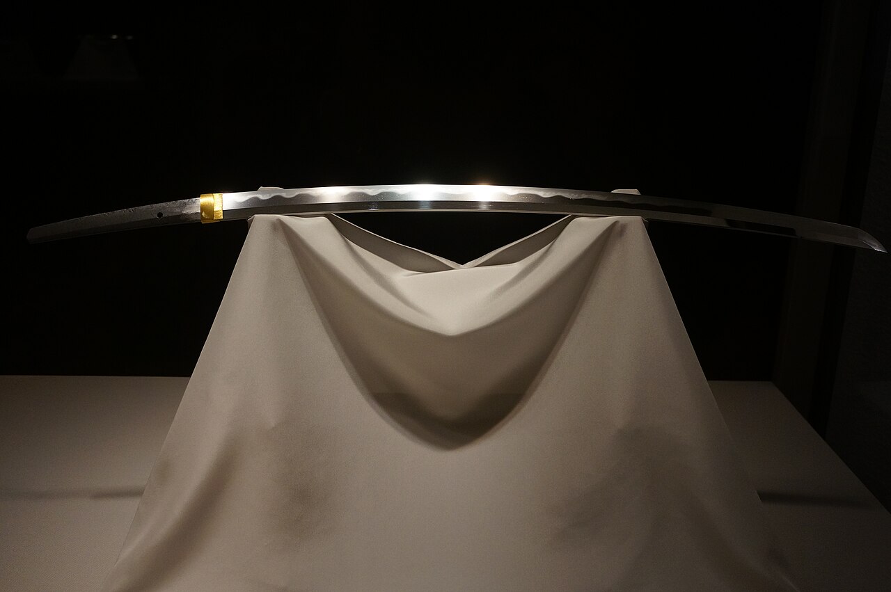 A katana forged by the legendary swordsmith Masamune, displayed on white silk
