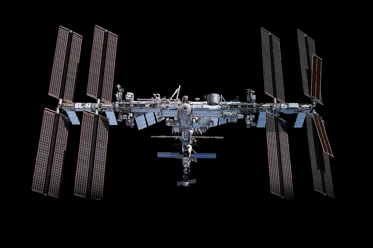 The International Space Station with its long solar arrays orbiting above Earth