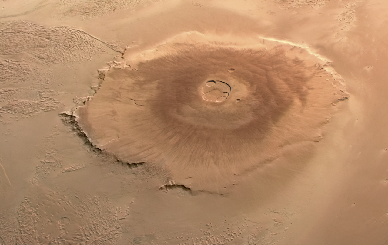 Overhead view of Olympus Mons on Mars, a vast shield volcano with a summit caldera