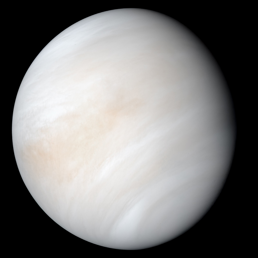 The planet Venus, wrapped in thick, pale clouds, seen as a full disk from space