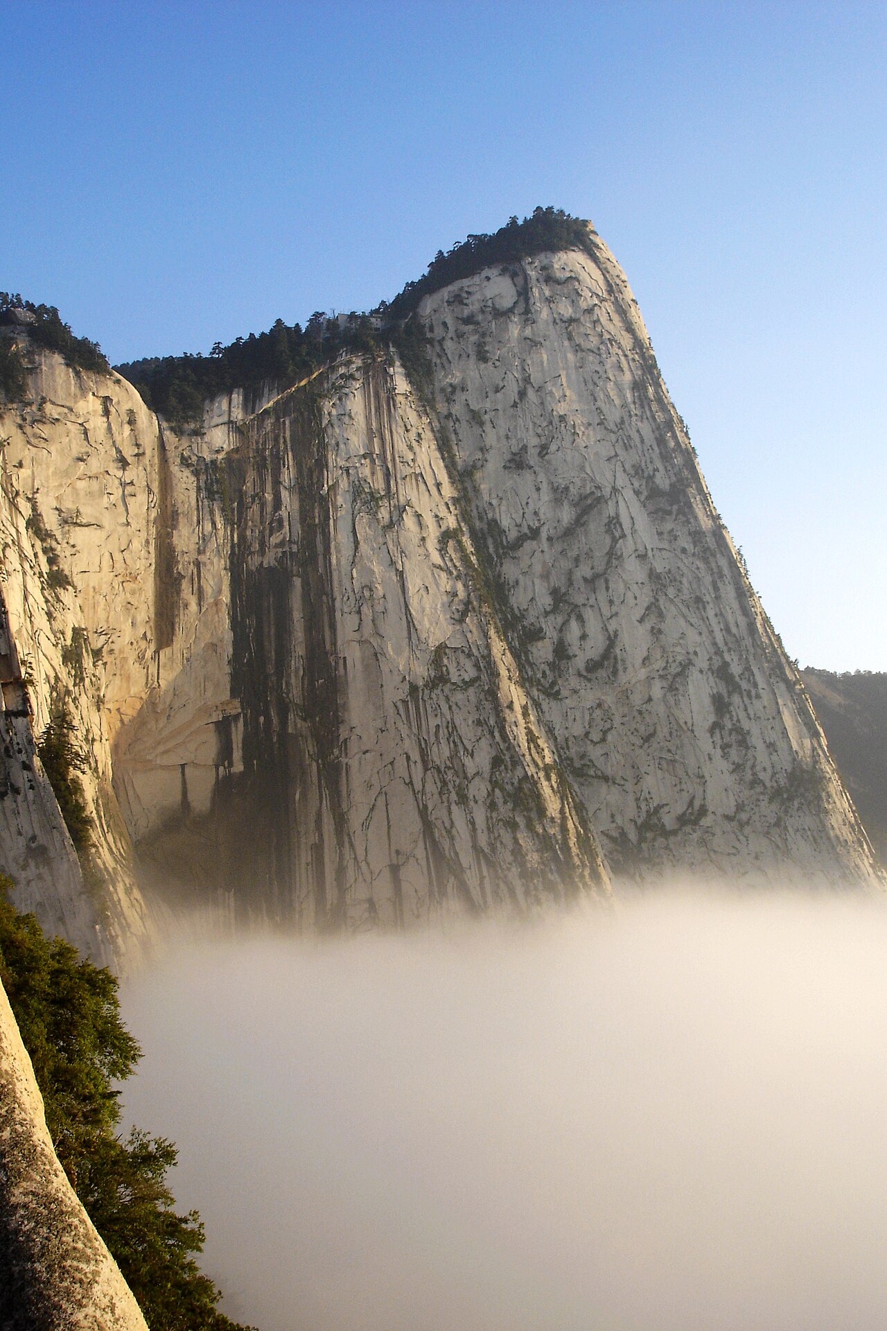 Steep granite peaks of Mount Hua in China with cliffs and narrow mountain paths