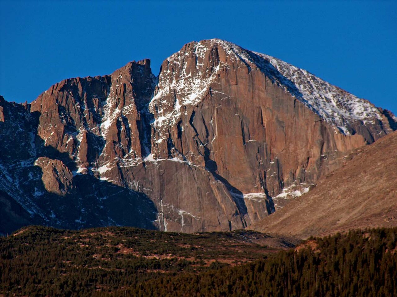The rocky summit of Longs Peak rising above alpine terrain in Rocky Mountain National Park