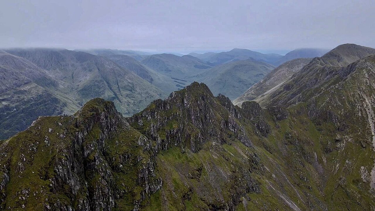 The jagged rocky ridge of the Aonach Eagach above the valley of Glen Coe, Scotland