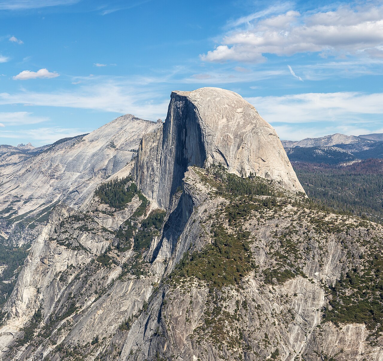 Half Dome's sheer granite face rising above the forested Yosemite Valley in California