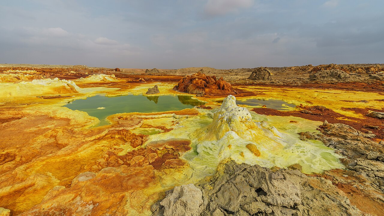 Yellow, green, and orange mineral deposits around acidic hot springs at Dallol, Ethiopia