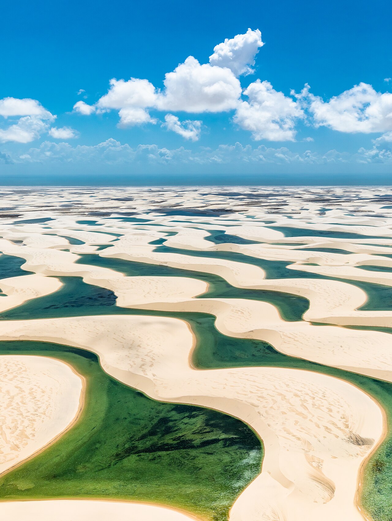 White sand dunes with blue rainwater lagoons in Lençóis Maranhenses National Park, Brazil