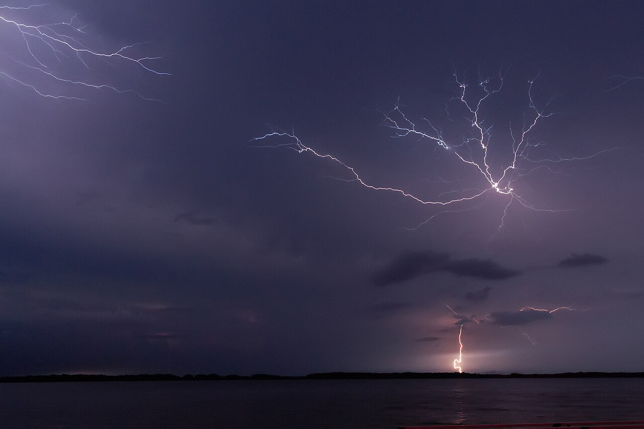 Lightning bolts striking from storm clouds over the dark waters of Lake Maracaibo