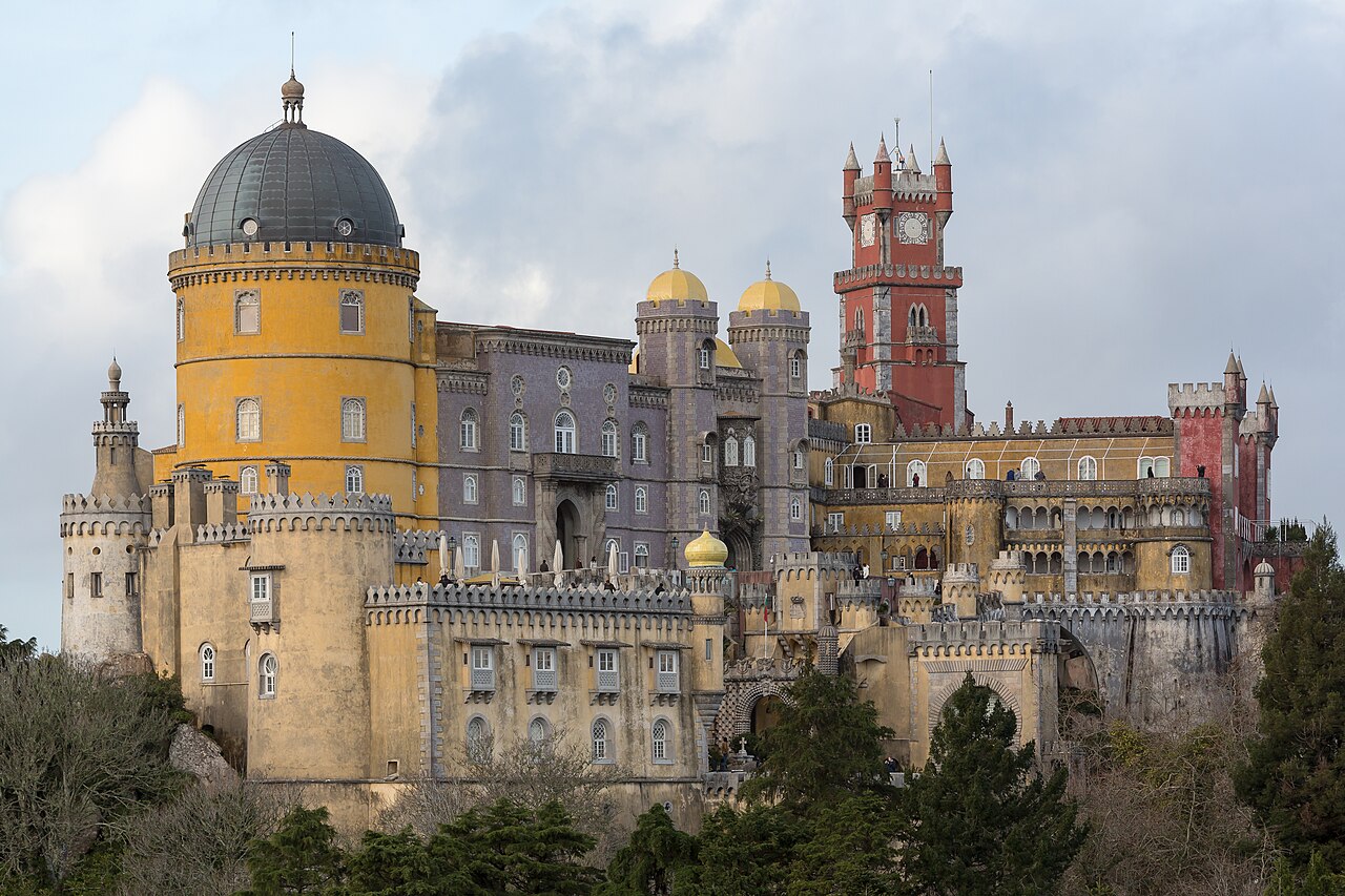 Pena Palace in Sintra with yellow and red towers on a forested hilltop