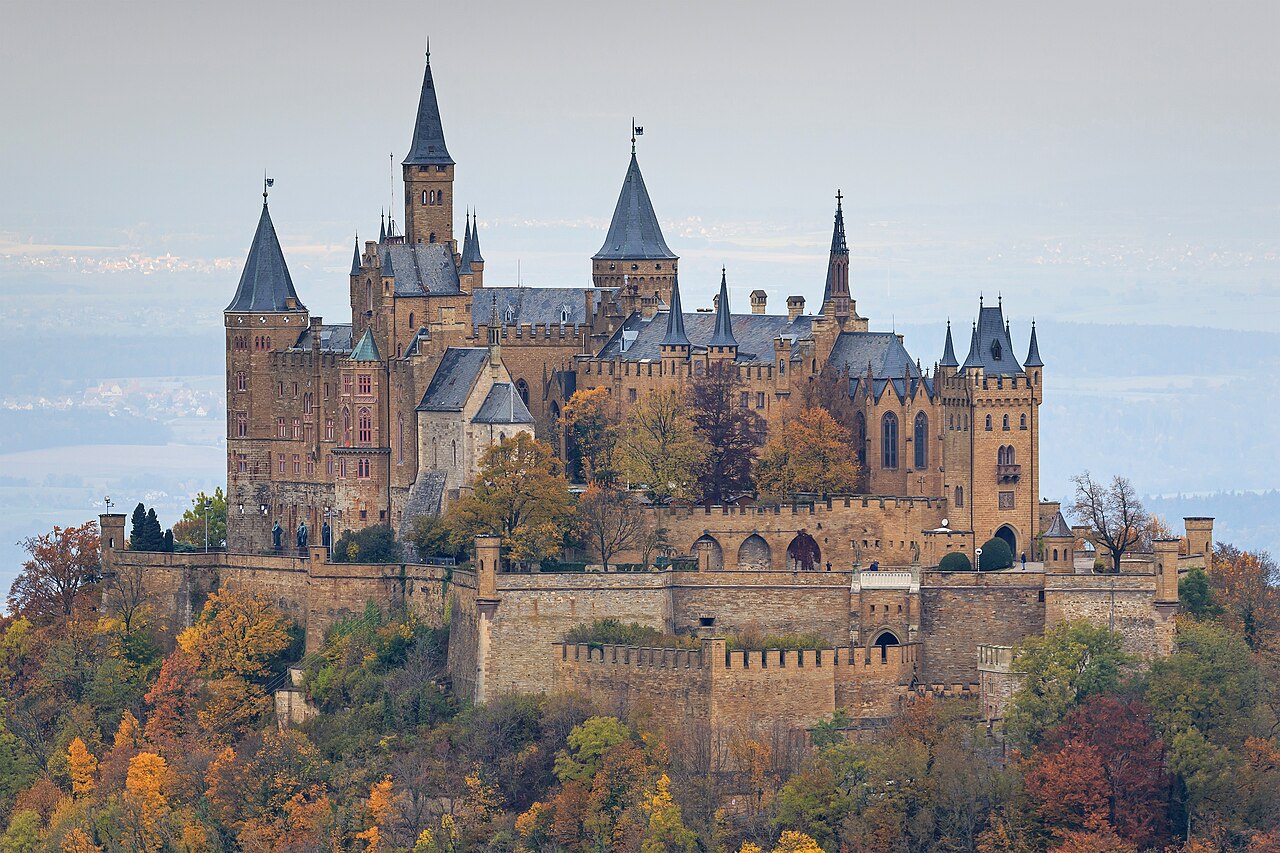 Hohenzollern Castle with towers and battlements on top of a forested mountain
