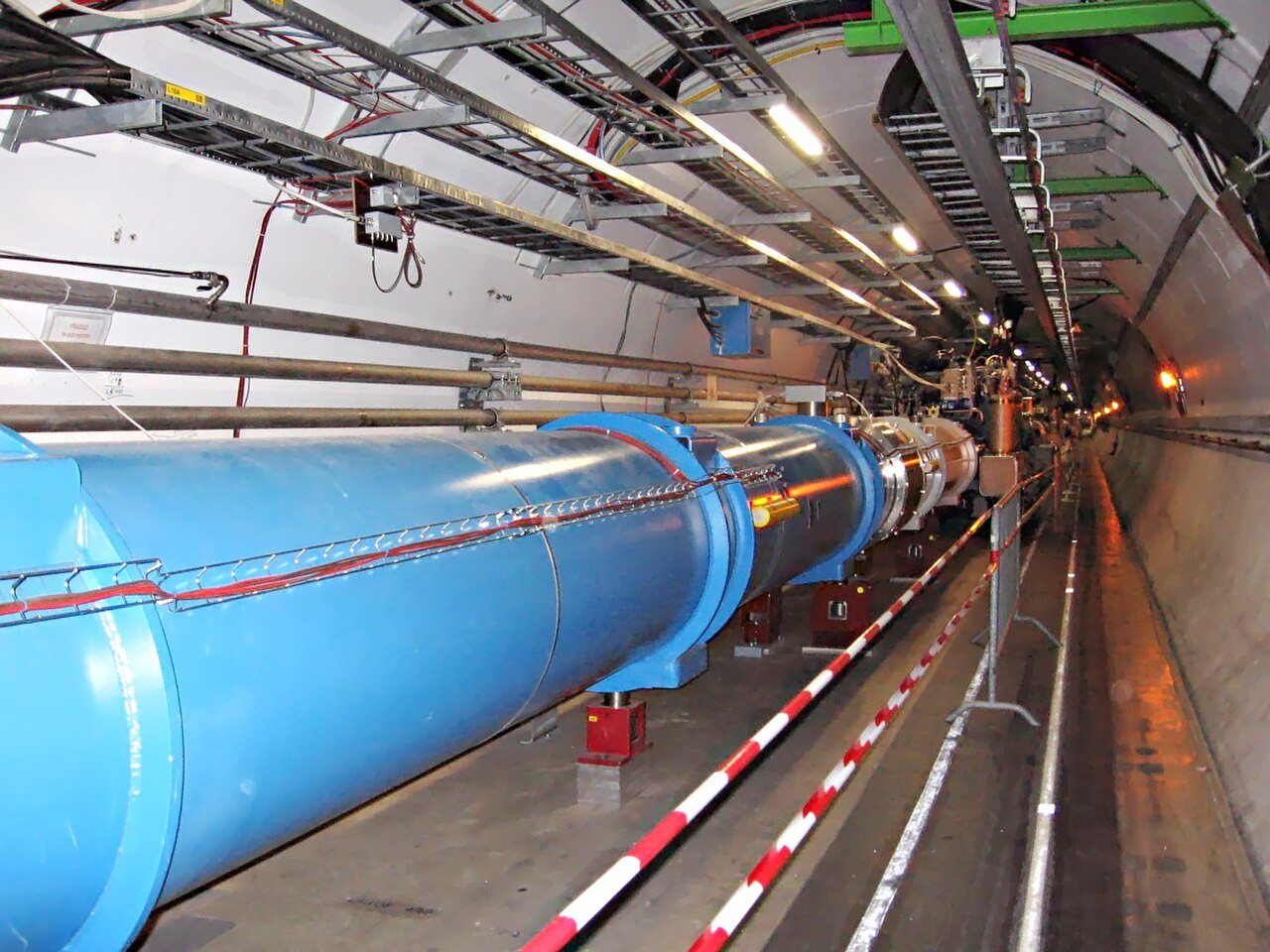 The blue magnets of the Large Hadron Collider stretching along its underground tunnel at CERN