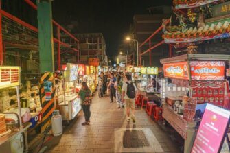 Crowds and brightly lit food stalls at Shilin Night Market in Taipei, Taiwan